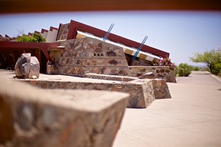 The rock wall formations ground the buildings into the desert landscape.