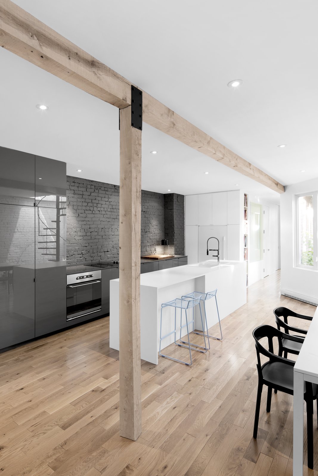 The original load bearing wall was replaced with a wood beam and vertical supports, creating a more open floor plan.