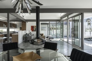 A suspended, Swedish fireplace hangs gently between the living and dining spaces, providing minimal separation, and warmth to all spaces.
