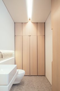 A Steel Staircase Merges Two Units Into One in Tribeca - Photo 4 of 13 - The powder room ceilings are designed to resemble abstract cloud formations. Beautiful wood joinery provides ample storage.