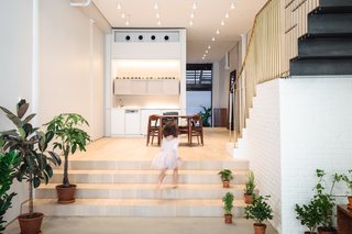 A Steel Staircase Merges Two Units Into One in Tribeca - Photo 2 of 13 - The steel stairs delicately land atop a white brick base. A brass handrail completes the circulation.