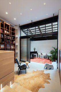 A Steel Staircase Merges Two Units Into One in Tribeca - Photo 6 of 13 - A light well draws daylight into the piano room, filling the back of the floor plan with diffused natural light.