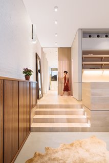 A Steel Staircase Merges Two Units Into One in Tribeca - Photo 7 of 13 - A large, beautifully detailed wood pocket door allows the back of the first floor to be closed off from the rest of the home, creating a private suite.