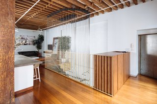 A Steel Staircase Merges Two Units Into One in Tribeca - Photo 12 of 13 - Adjacent to the elevator, the main entry houses a custom millwork piece for gathering everyday essentials.