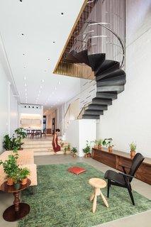 A Steel Staircase Merges Two Units Into One in Tribeca - Photo 9 of 13 - The stairs partially suspend from the ceiling above, allowing the living space to maintain its usable space and height.