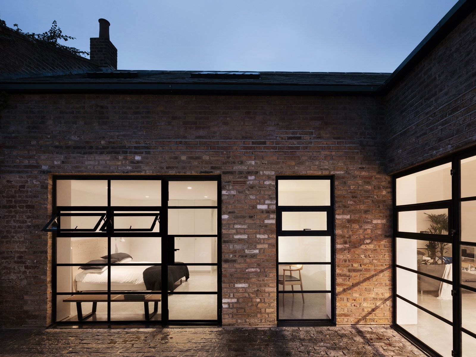 Gridded steel frame windows were added throughout the home to provide natural daylight to a city dwelling, unique for a London Residence of this type.