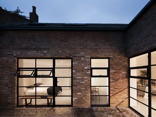 Gridded steel frame windows have been added throughout the home to provide natural daylight to the city dwelling, unique for a London residence of this type.