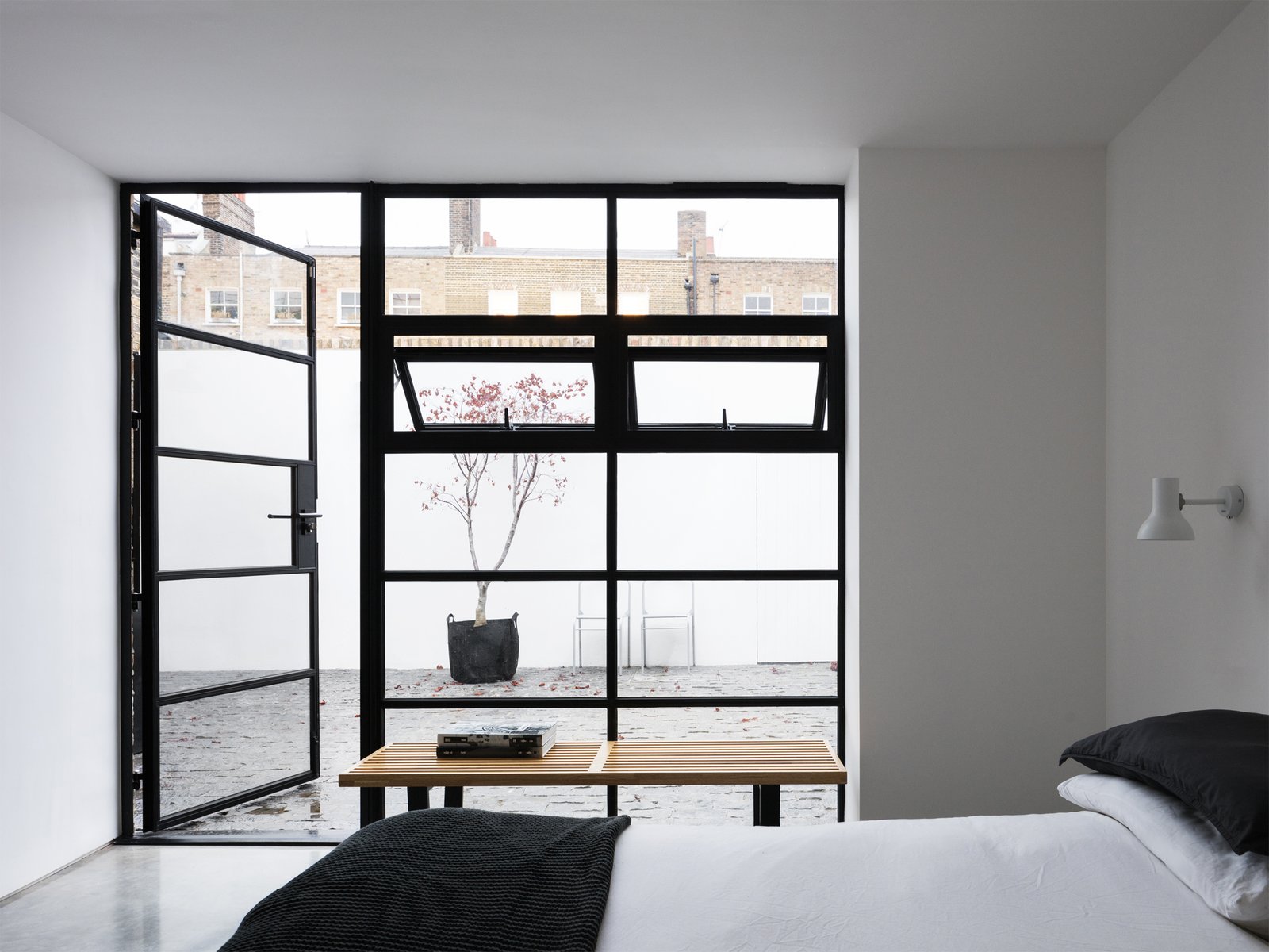A interior courtyard is accessible from the bedroom, providing an unexpected secluded oasis right in the heart of an urban setting.