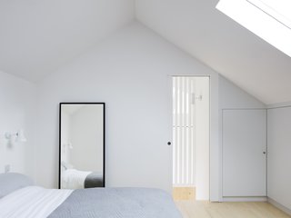 Vaulted ceilings allow for a spacious loft, complete with the second bedroom. Skylights draw plentiful daylight into the airy space.