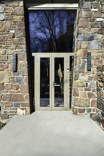 A balance of solidity and void, weight and transparency, and elegance and masculinity define the residence's exterior. Masonry walls define the shape, while glass infills the negative space between.