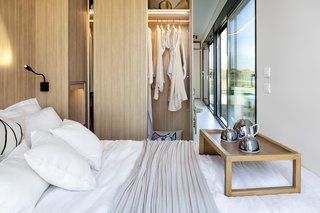 Built-in closets create a wall between the sleeping quarters and living spaces, allowing for more storage space.