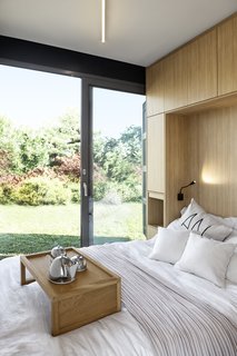 Large windows draw daylight into the sleeping quarters, while providing beautiful views to the gardens.