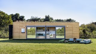 Large, sliding glass doors connect the interior living spaces to the garden, while drawing in plentiful daylight.