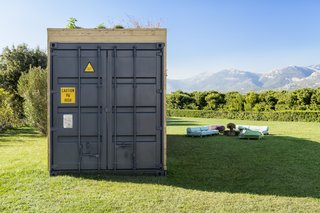 The end elevation displays the shipping container structure and original doors. 