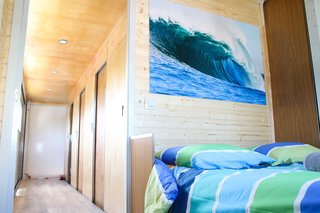 One double guest room anchors the upstairs sleeping quarters. Beach-inspired colors and imagery draw the ocean in.
