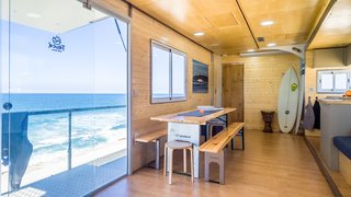 Large sliding glass doors draw in plenty of daylight while providing beachfront access.