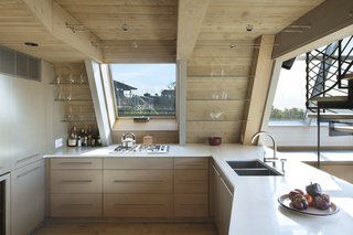 Millwork is intricately detailed in the kitchen, blending function with beauty. Windows provide views from every direction while cooking or entertaining.