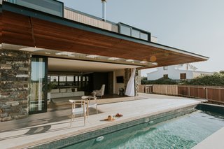 The outdoor swimming pool is just steps from the comfort of the living spaces.