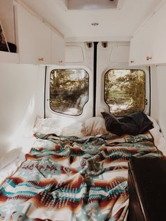 Memory foam pillows, a Pendleton wool blanket, and a memory foam mattress transformed the original van into the perfect nighttime retreat.