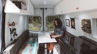 The interior of the van incorporated the couple's personal style. Artwork and blankets also reflected their artistic aesthetic.