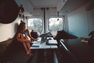 In their old van, the bench and table served as the ideal workspace for the traveling couple. 