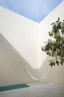 During the day, light and shadows create abstract forms along the facades of the courtyard, providing different perspectives as the sun passes over.