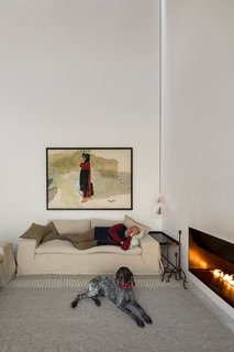 Nomadic artwork makes its appearance throughout the home, providing an accent to the mostly white surfaces.