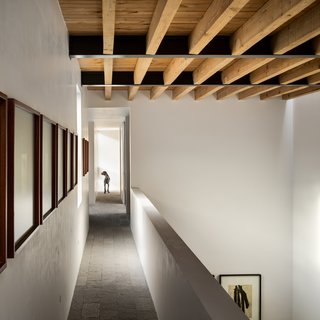 Artwork lines the walkway that connects the two ends of the upper floor. 