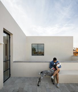 A rooftop terrace provides views of the surrounding neighborhood.