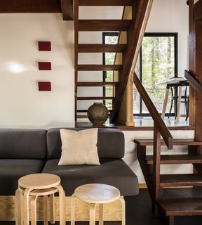 Open wood stairs allow light to pass between levels.