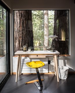 A small office space overlooks the redwood surroundings.