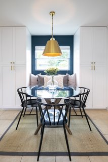 The deep blue color is extended into the dining space, and provides a colorful accent to the back wall of the seating area.