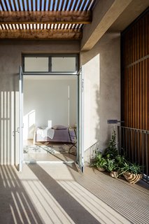 A covered balcony is located off of the bedrooms on the upper floor.