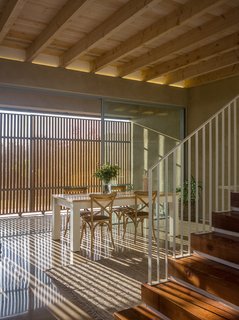 The wood shutters provide ever-changing patterns of light. As the sun changes throughout the day, the light falls in diverse patterns through the light-filtering screens.