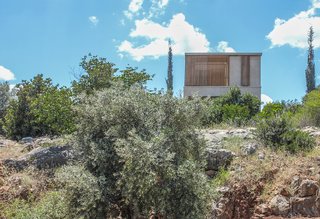 The residence appears as a simple box perched at the edge of the rocks. Simple in form, the intricate thoughtfulness to site and character is concealed.