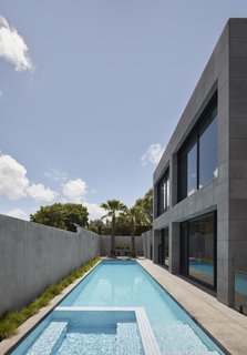 The side yard is filled with a long, narrow built-in swimming pool. It is the perfect environment to enjoy the Australian sunshine. 