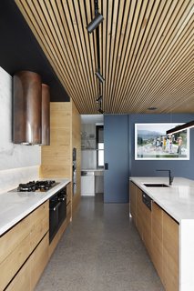 The copper hood makes a bold statement in the subdued kitchen.