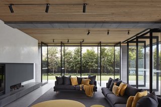 Continuous materials and expansive operable glazing blur the boundaries between interior and exterior, drawing the natural elements inward.