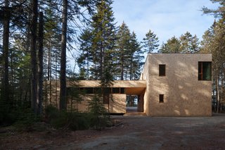 The two, season-specific wings of the L-shaped plan are separated by a covered breezeway.