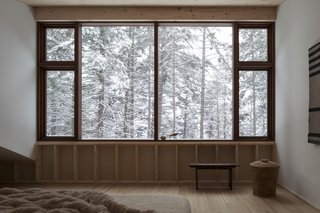 The large windows in the master bedroom provide the feeling of sleeping within the tree tops.