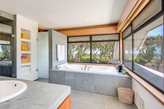 In the master bath, views remain continuous. A neutral palette of finishes creates a serene retreat.