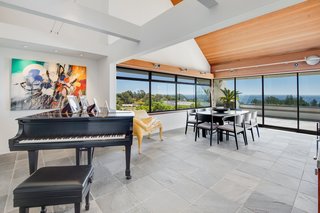 Slate tiles, white walls, and wood accents form the ideal backdrop for an eclectic collection of contemporary art and furnishings.