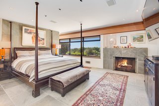 The master bedroom comes complete with its own fireplace and astounding views.