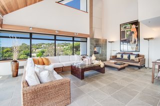 Large windows offer expansive views of the Malibu hillside.