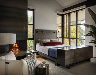 The master bedroom features a custom leather-and steel bed, a collaboration by Geremia and fabricator Tod Von Mertens, and a rolled-steel and Thassos marble fireplace.