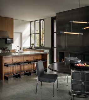 The Olson Kundig-designed kitchen features green soapstone countertops and oak veneer cabinets, with custom Olson Kundig hardware.