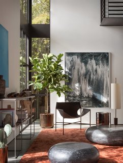 Laurier Blanc acrylic glass Hekla Side Table & Stool, embedded with burnt wood trunk, complements Taylor Forrest Club chairs beneath Amir Zaki photograph "Silver 03" from James Harris Gallery in Seattle.