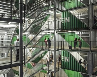 Exposed stairways and connecting bridges resemble the back side of a billboard.