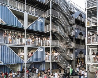 Circulation platforms weave above the open courtyard space.