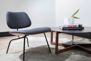 The circular Pi coffee table by Blu Dot and a classic, padded Eames Lounge chair are the perfect combination.